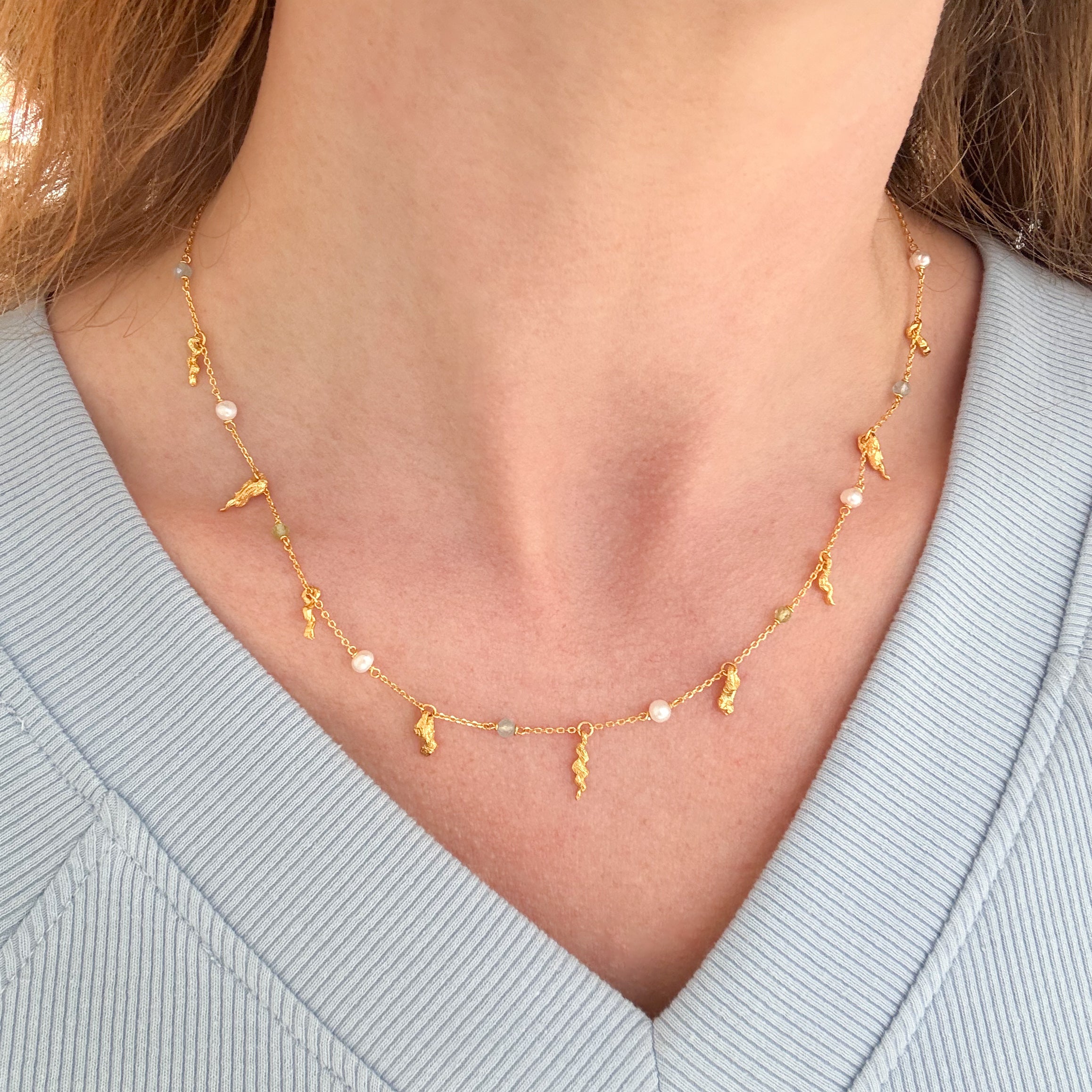 Detaljeret halskæde med perler og vedhæng